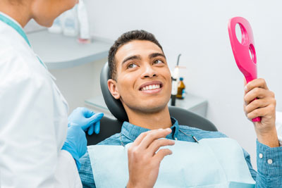 patient smiling after a cosmetic dentistry procedure in Chatsworth, CA