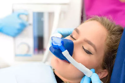 woman asleep for her dental procedure thanks to sedation